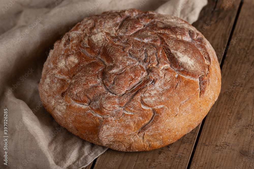 Fresh crusty homemade bread on wooden table. Fresh crusty homemade bread on wooden table.