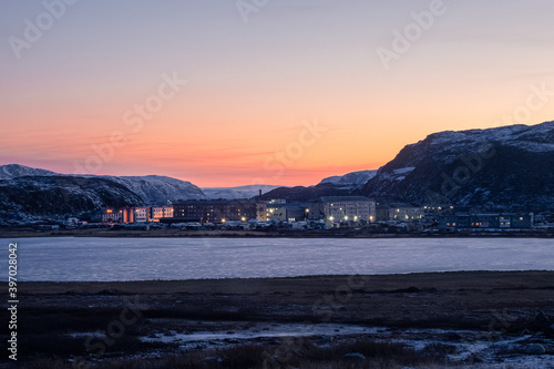 Winter Teriberka. Evening polar landscape with the village of Lodeynoye located between the polar hills photo