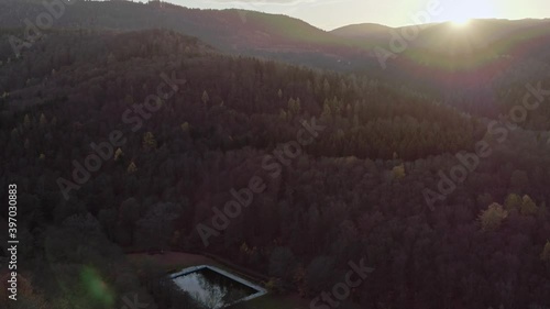 Drone pan left flight forward over autumn, moody trees and beautiful landscape in Schwarzenburg , Germany photo