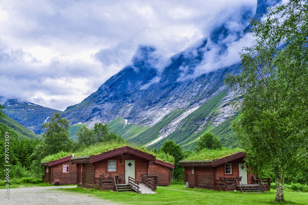 Authentic cabins with green grass on the roof at the foot of the popular Troll Stair or Trollstigen serpentine road. Authentic cabins with green grass on the roof at the foot of the popular Troll Stair or Trollstigen serpentine road.