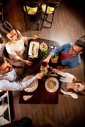 Young people having dinner ...