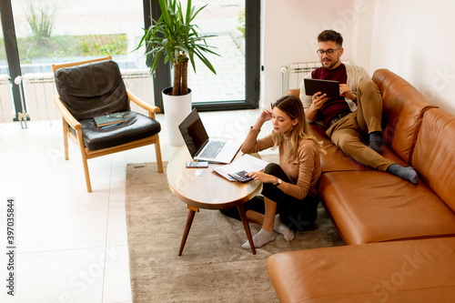 Young woman using laptop an...