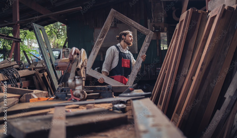 Carpenter man cutting wood with saw. craftsman working workshop factory industry. Capenter worker with mask protection. Carpenter man cutting wood with saw. craftsman working workshop factory industry. Capenter worker with mask protection.