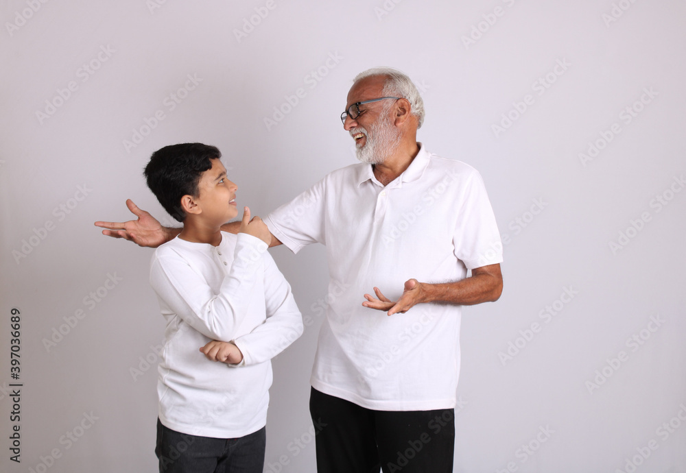 Happy Indian grandfather and grandson spending quality time