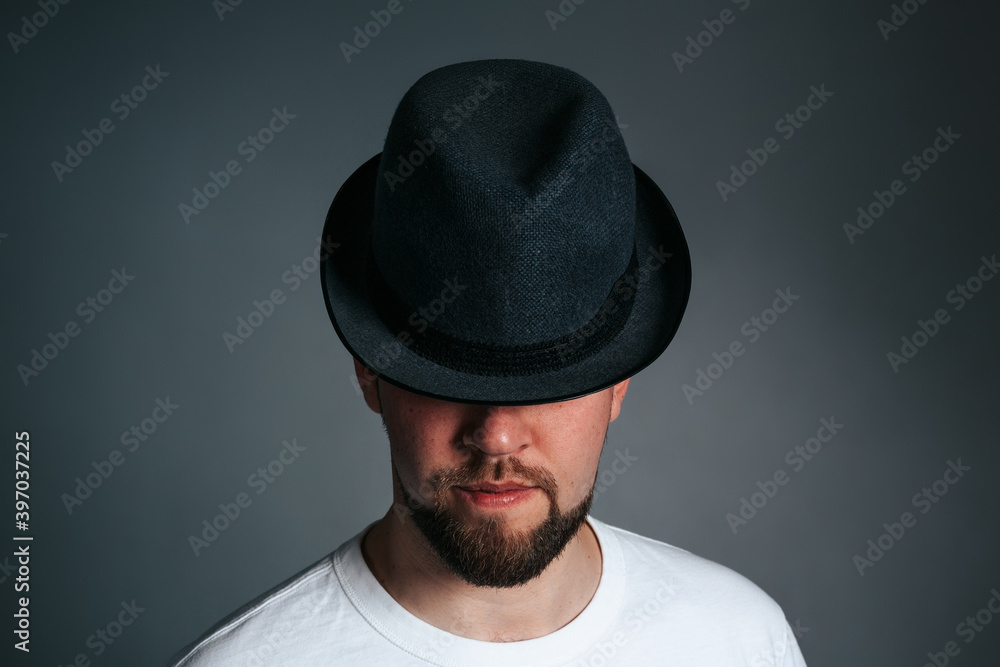 Handsome Bearded Man in Hat. On a grey background Handsome Bearded Man in Hat. On a grey background