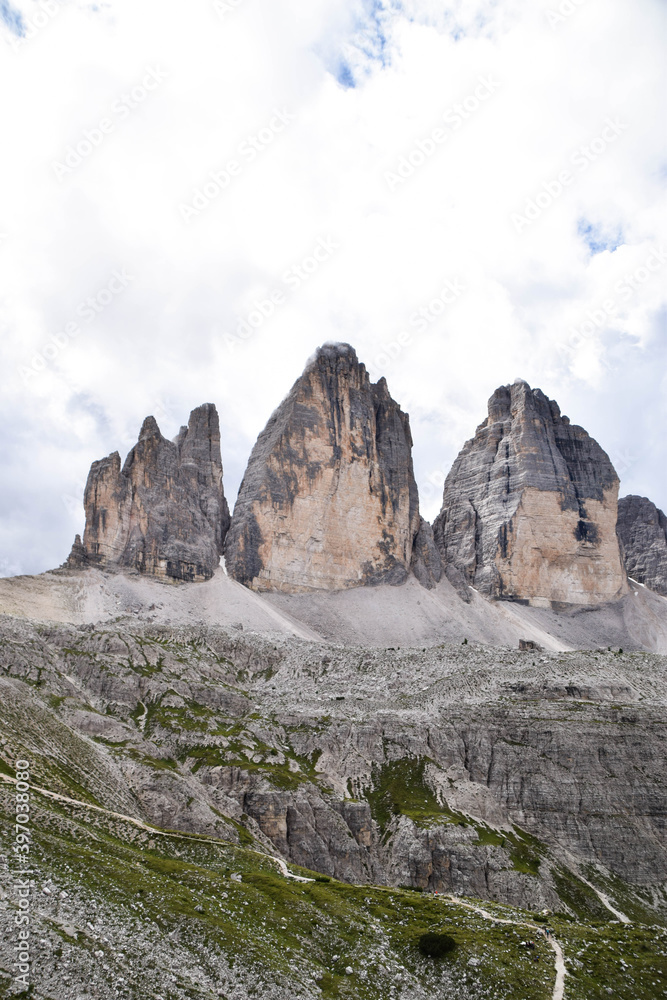 The National Park Tre Cime di Lavaredo. The three peaks. Blue sky, clouds, mountains, landscape, dolomites, alps. The National Park Tre Cime di Lavaredo. The three peaks. Blue sky, clouds, mountains, landscape, dolomites, alps.