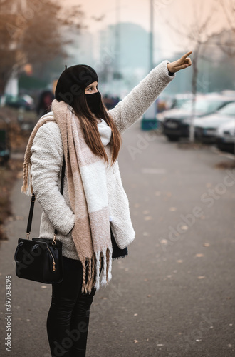 Young girl in a big city showing smotehing