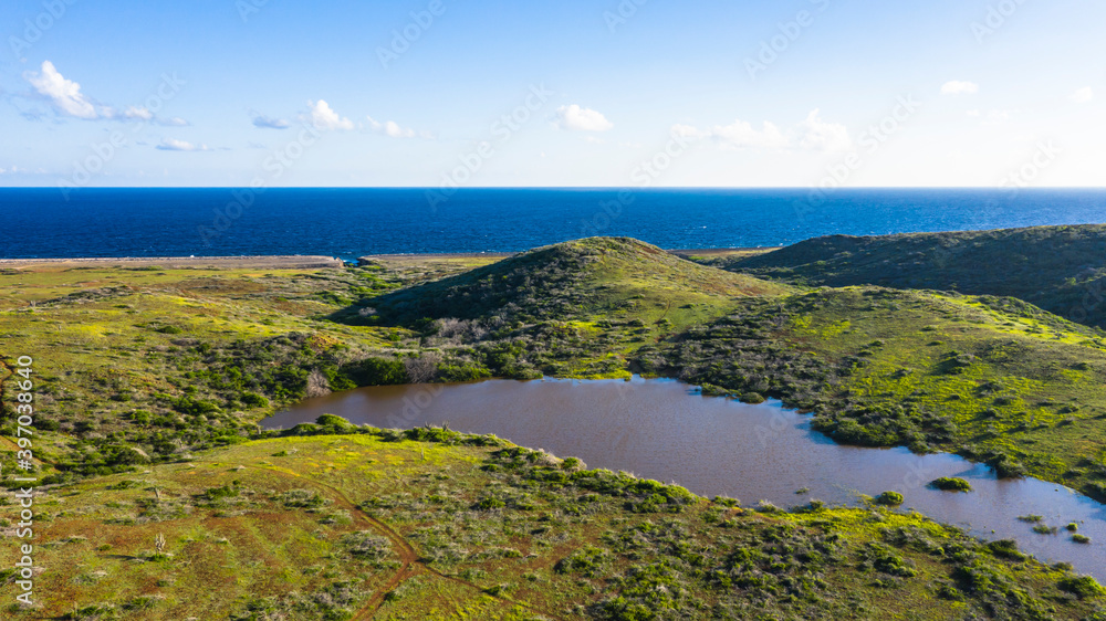 Aerial scenery over hills and lake above Caribbean Island of Curacao