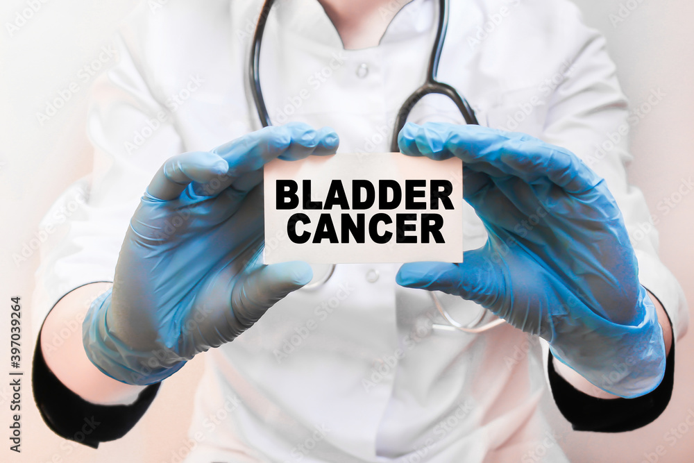 The doctor's blue - gloved hands show the word BLADDER CANCER - . a gloved hand on a white background. Medical concept. the medicine The doctor's blue - gloved hands show the word BLADDER CANCER - . a gloved hand on a white background. Medical concept. the medicine