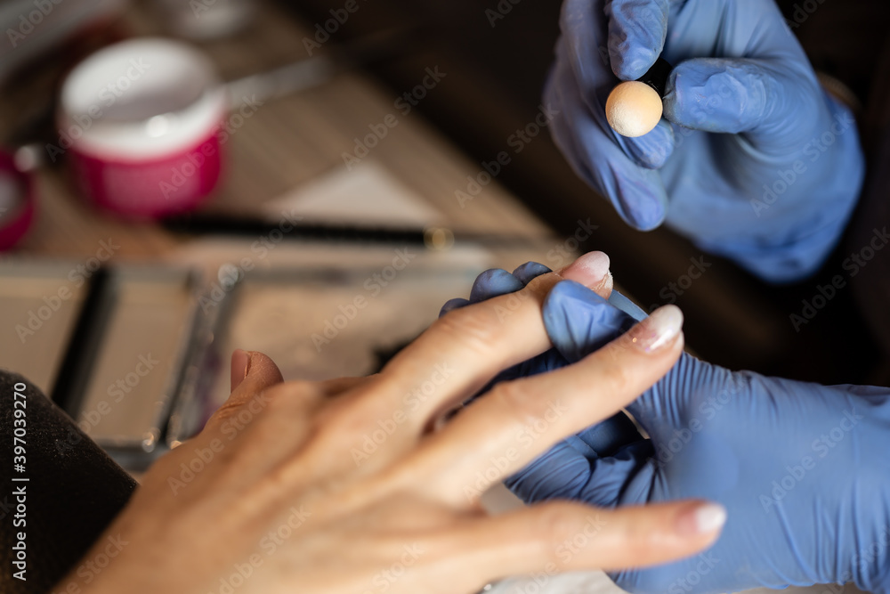 Closeup shot of a woman in a nail salon receiving a manicure Closeup shot of a woman in a nail salon receiving a manicure