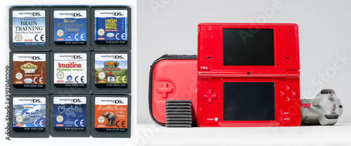 lodnon, england, 05/05/2019 A gloss red nintendo ds i hand held vintage console on a white studio background. Retro video gaming handset. nostalgic computer and arcade games. Stock Photo Adobe Stock