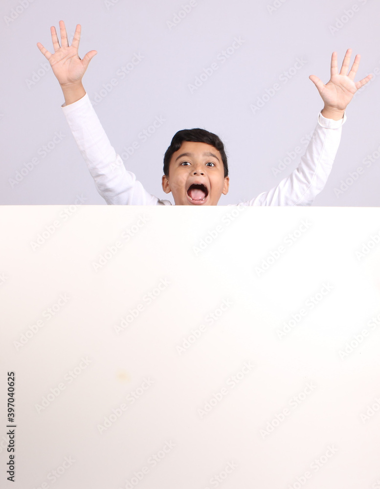 Young Indian schoolboy showing blank copy space. Young Indian schoolboy showing blank copy space.
