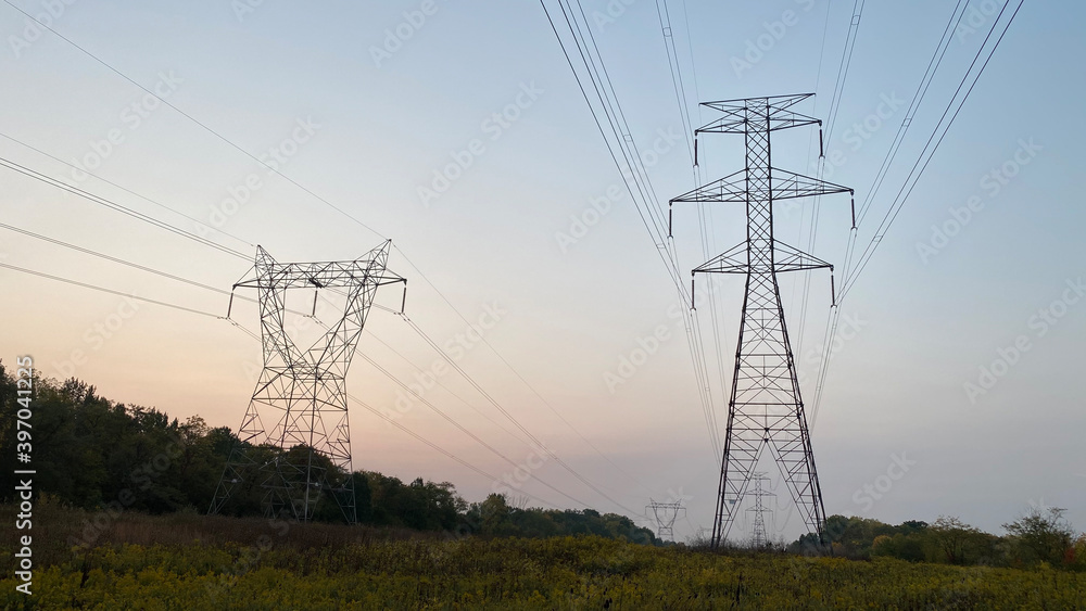 Fototapeta premium Power lines are held up by transmission towers.