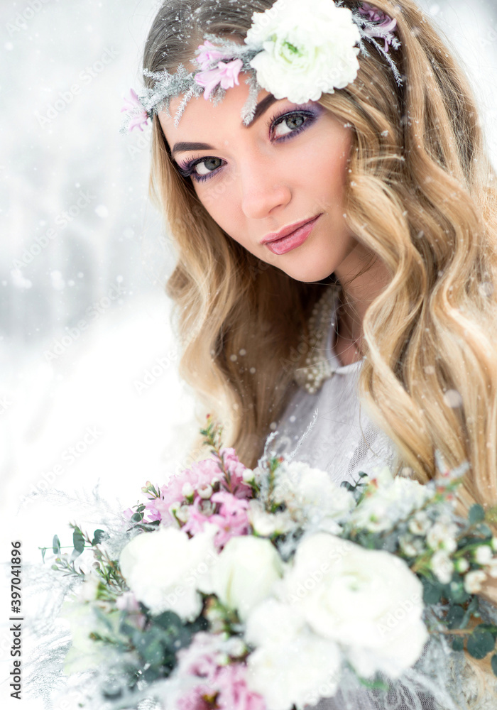 Winter beautiful woman in snow forest with flower wreath and bouquet. Bride makeup and hairstyle Winter beautiful woman in snow forest with flower wreath and bouquet. Bride makeup and hairstyle