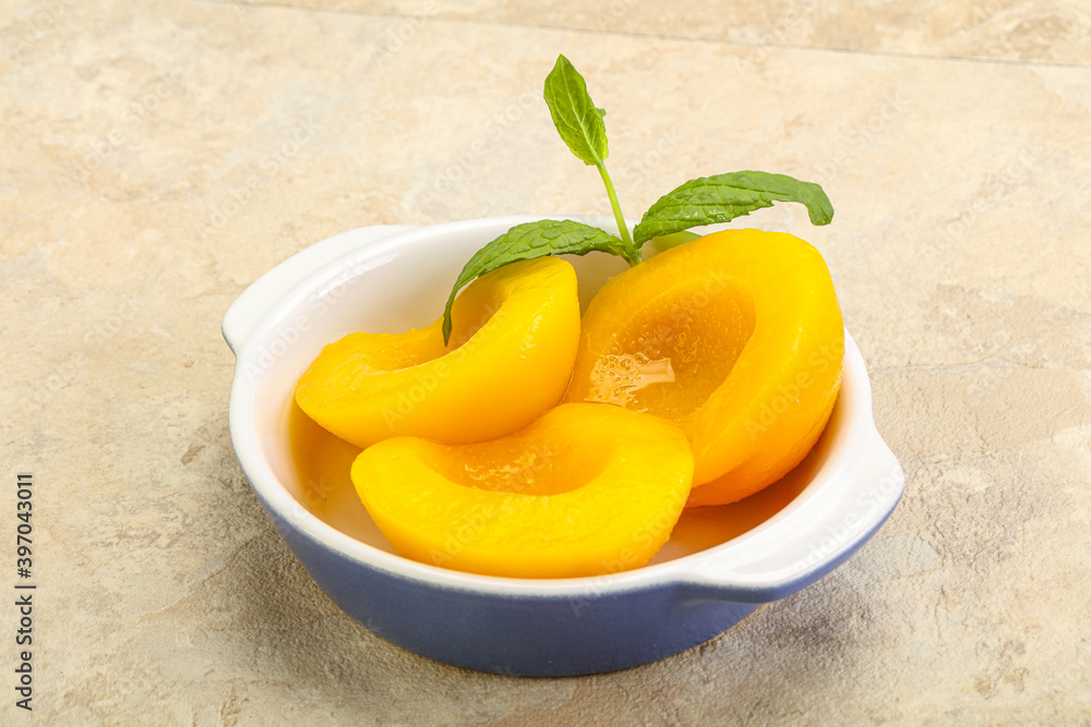 Sweet ripe canned peaches with mint