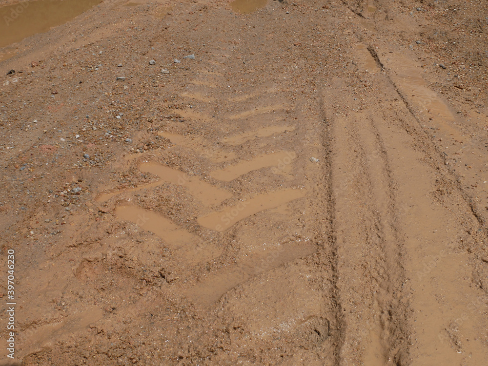 The mark of heavy vehicle tires that have gone through a muddy soil. 