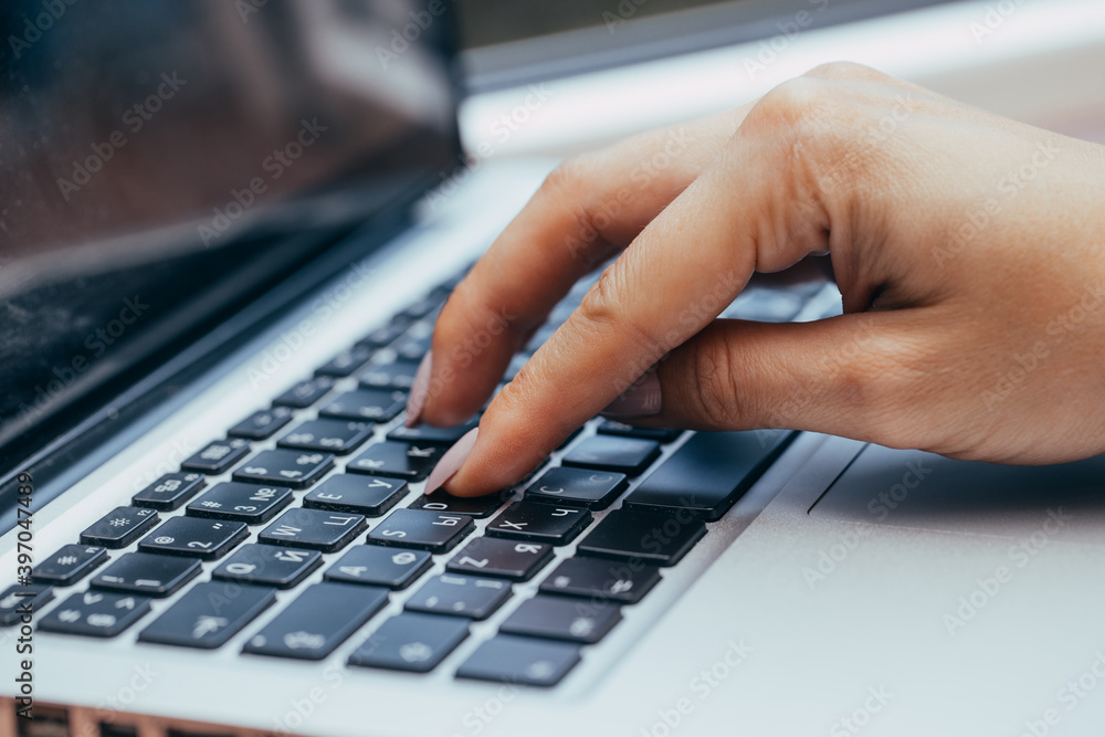 Hands writing ond a keyboard of a laptop or a notebook in Home Office Hands writing ond a keyboard of a laptop or a notebook in Home Office