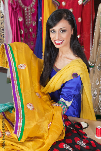 Portrait of an Indian female dressmaker holding sari