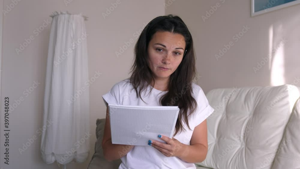 Young business woman wears headset talks to web camera making distance online video conference call. Female internet teacher doing distant chat working from home. Webcam view Young business woman wears headset talks to web camera making distance online video conference call. Female internet teacher doing distant chat working from home. Webcam view