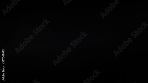 Defocused light glare from incandescent lamp on black background HD