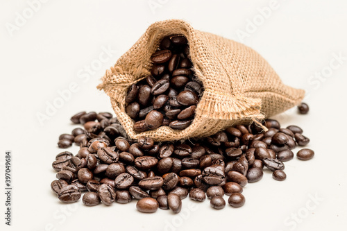 coffee beans in sacks bag isolated white background.