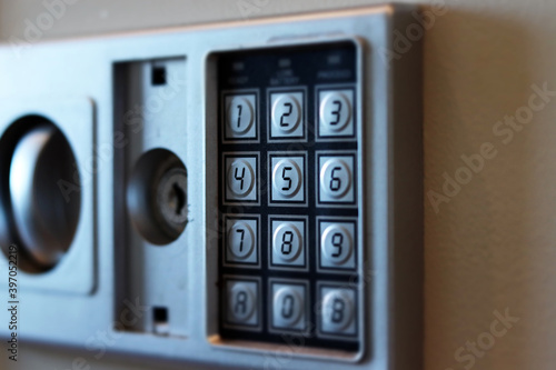 Blurred safe with combination lock in a hotel room, closeup numbers with tilt shift effect. Selective focus