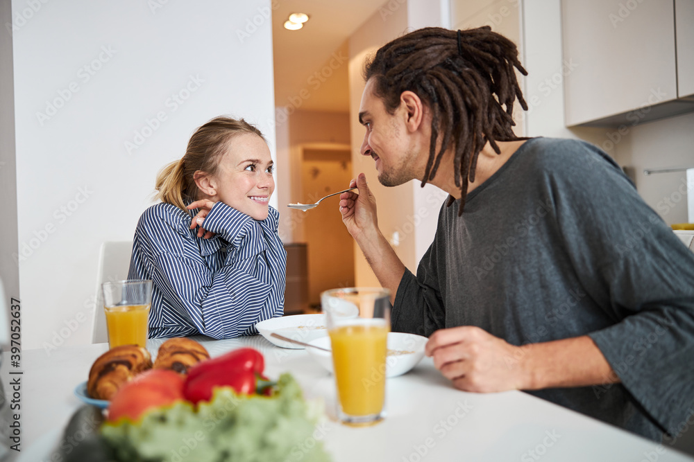 Beautiful couple in love enjoying breakfast at home Beautiful couple in love enjoying breakfast at home