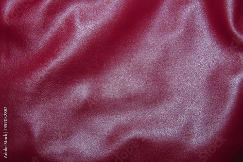 Leather burgundy background with pleats. Red Leather Texture Background.