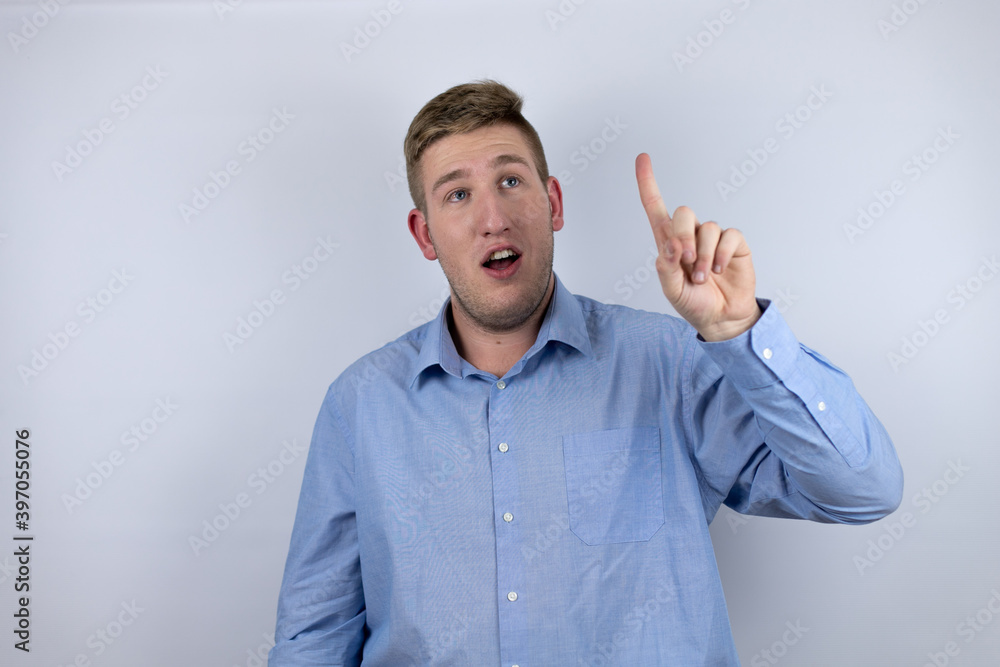 Business young man wearing a casual shirt over white background having an idea Business young man wearing a casual shirt over white background having an idea