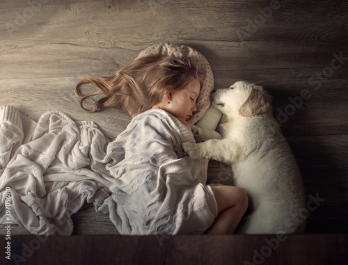 girl with a puppy sleeping on the floor, friendship, golden retriever