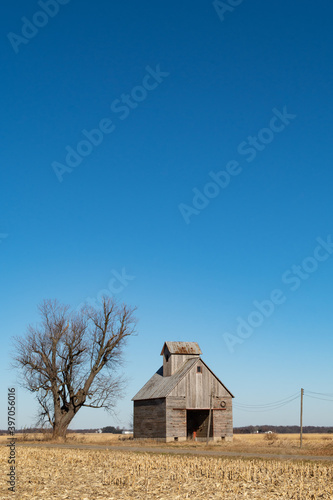 Isolated corn crib barn in a barren winter landscape. Illinois, USA.