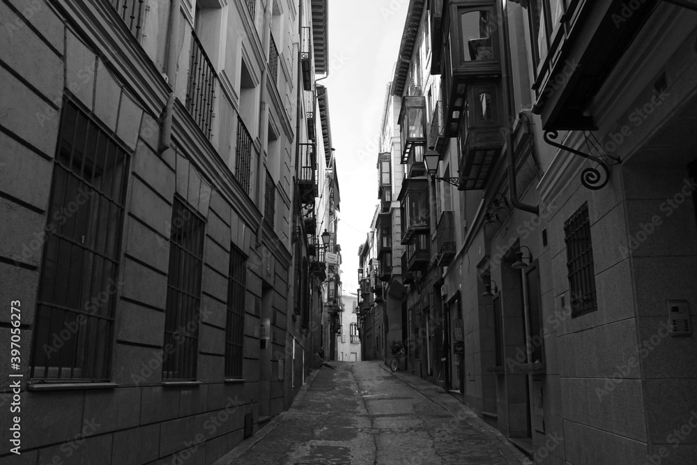 Toledo medieval narrow streets in black and white, Spain.