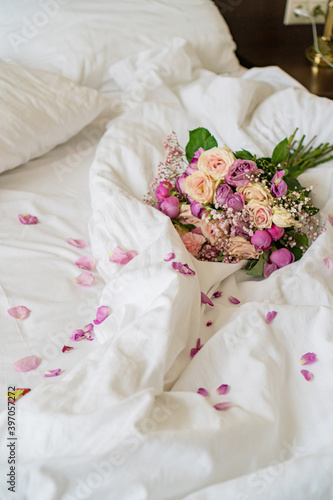 there is a bouquet of flowers on the bed