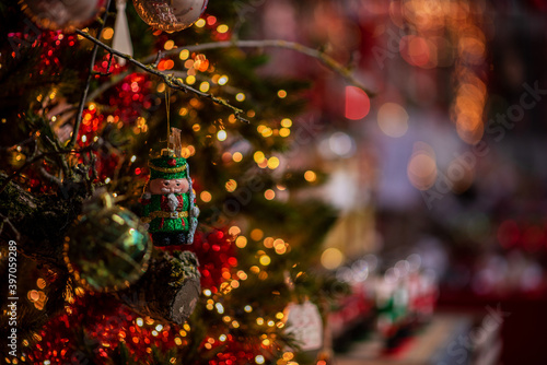 Decorated Christmas tree on blurred background. New Year's and Christmas holiday background with lights on tree. © eskstock