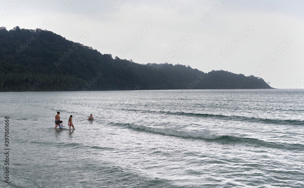 People bathing on the beach of the coconut island