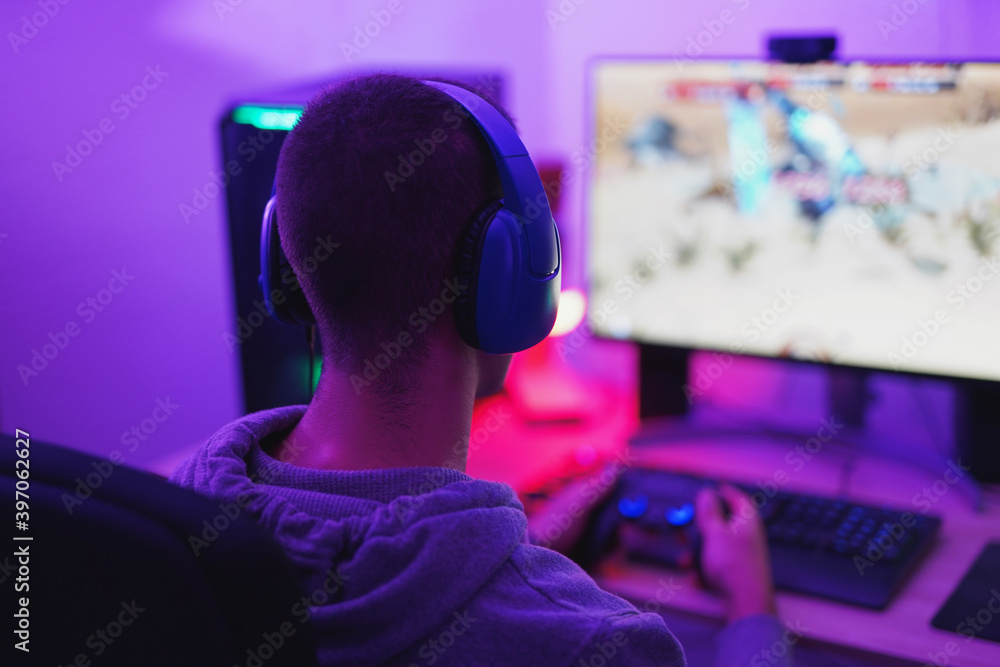 Young man wearing headset and play video games online - Home isolated for coronavirus outbreak Young man wearing headset and play video games online - Home isolated for coronavirus outbreak