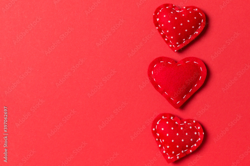Fototapeta premium Top view of textile hearts on colorful background. Valentine's day concept with copy space