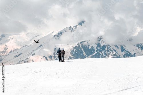 people, bird on a snowy mountainside, mountain landscape of the North Caucasus, Russia