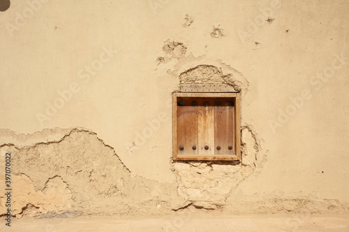 An old window on the walls of the houses of the city of Al-Hofuf in Al-Ahsa. Saudi Arabia . photo