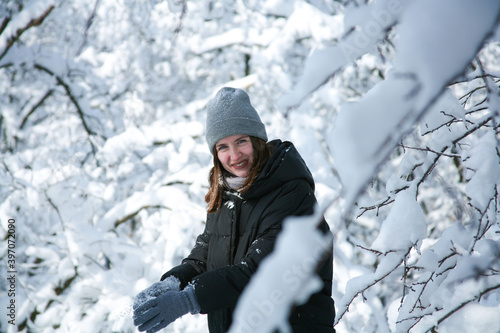 Young woman walks in the winter forest. Russian Winter. Too much snow