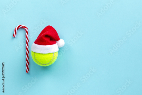 smiley yellow tennis ball in santa hat , xmas decoration, tennis sport concept