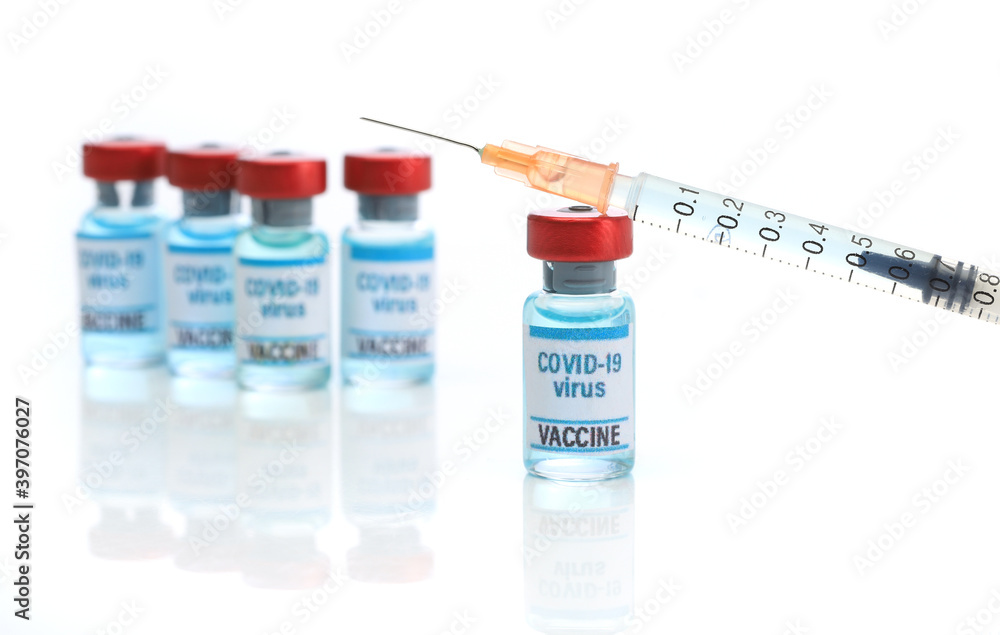 Covid 19 vaccine. Medical ampoules and syringe isolated on white background Covid 19 vaccine. Medical ampoules and syringe isolated on white background
