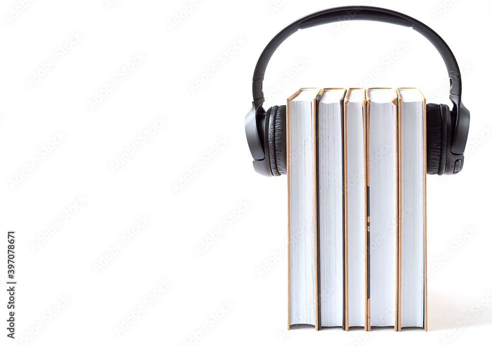 headphones and books on a white background. Audiobook concept headphones and books on a white background. Audiobook concept