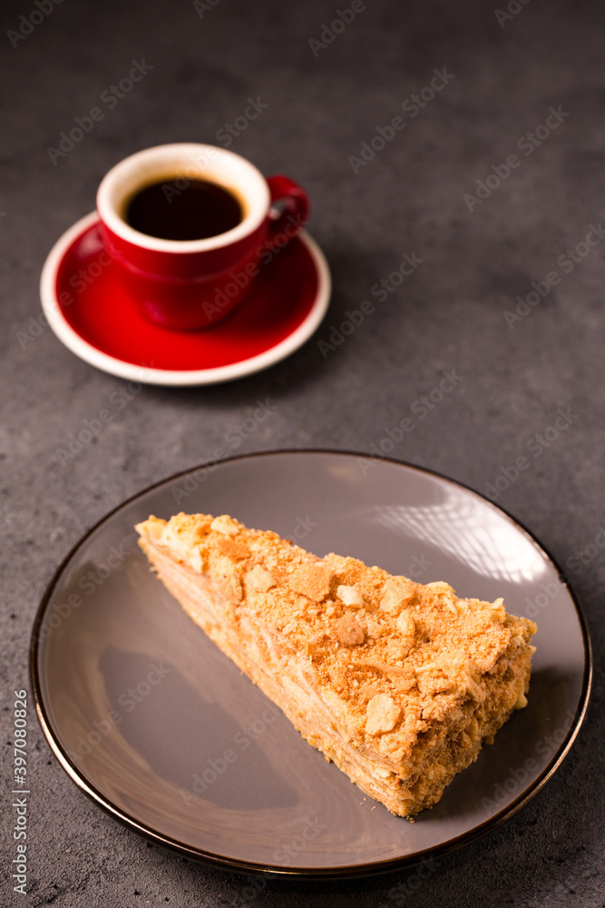 Napoleon cake close-up and coffee on a gray background Napoleon cake close-up and coffee on a gray background