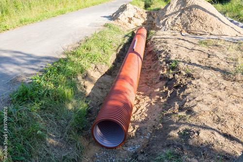 Wallpaper Mural corrugated plastic pipe in orange color for the entrance lies in the ditch Torontodigital.ca