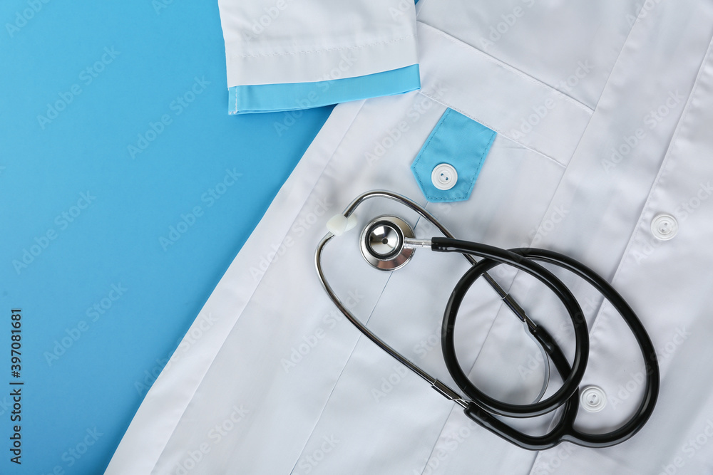 stethoscope and medical gown top view on blue background stethoscope and medical gown top view on blue background