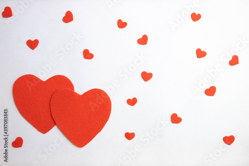 two red hearts and small hearts on a white background