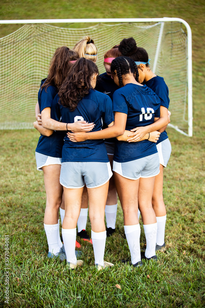 Female team huddled together before game Female team huddled together before game