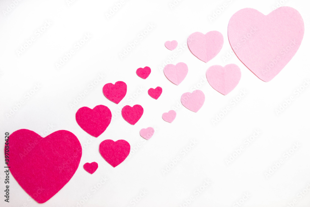 pattern of red and pink hearts lies on a white background