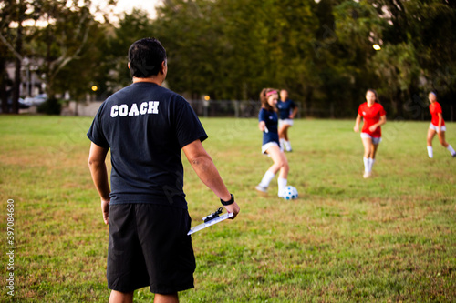 Man coaching girls soccer team